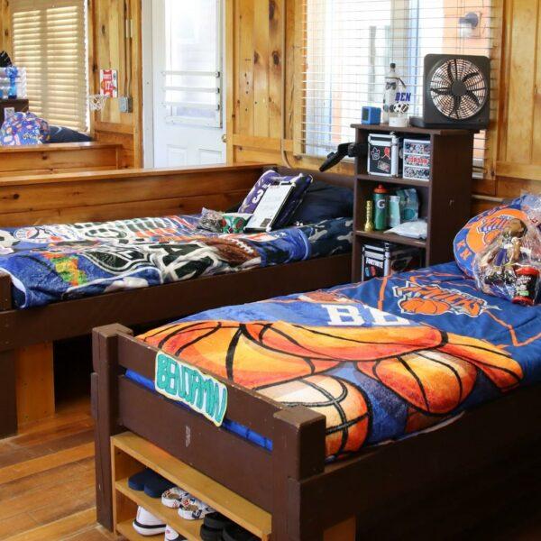 Interior of boys cabin with neatly made beds always.