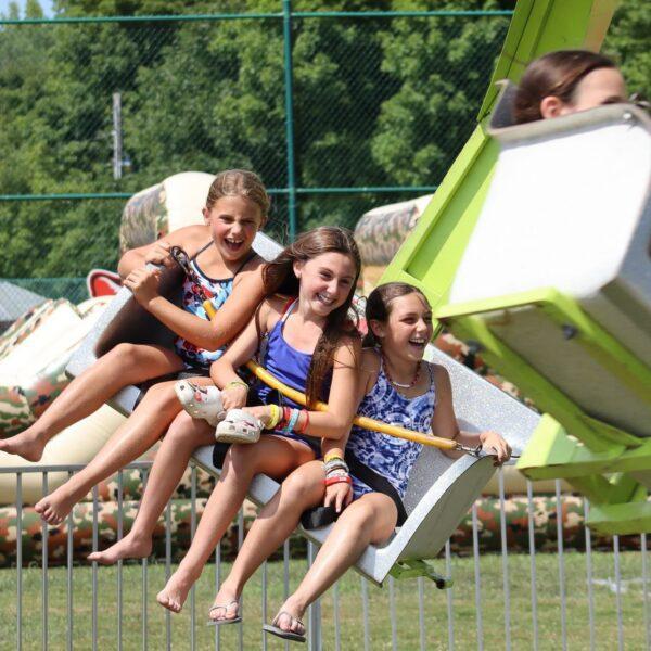 3 happy girls on a theme park ride