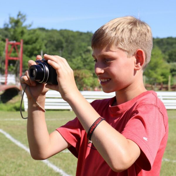 Boy holding a camera and about to shoot