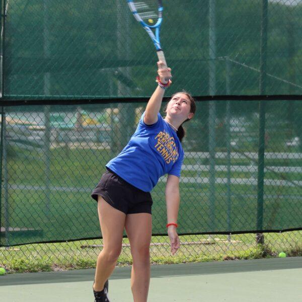 Girl about to smash tennis ball