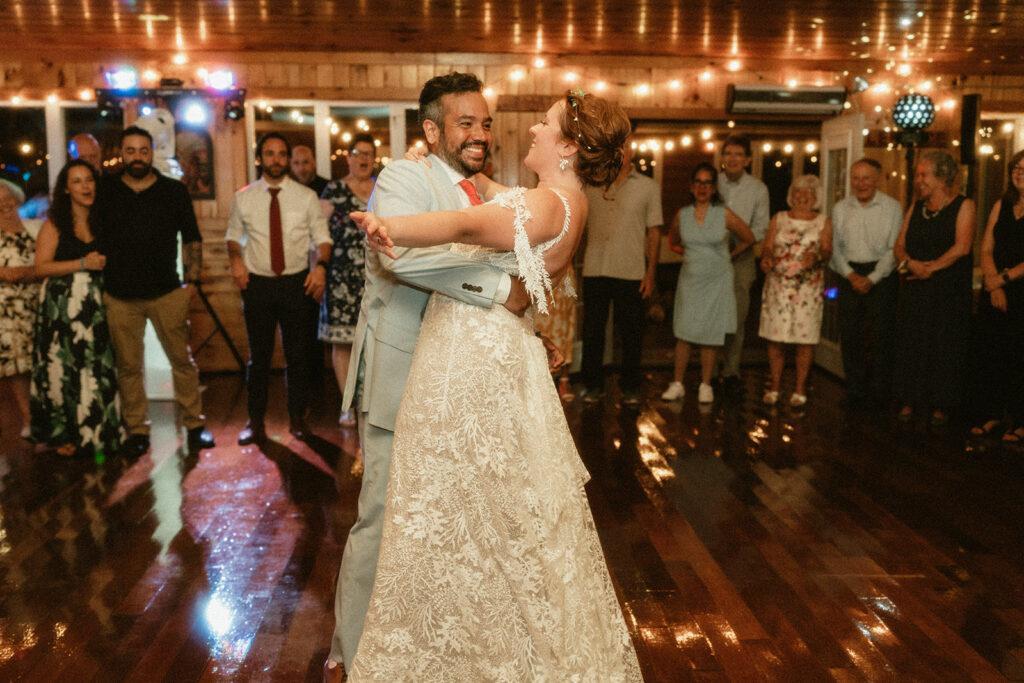 2 newlyweds dancing in front of a crowd