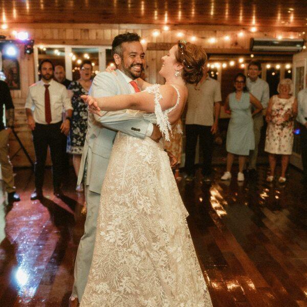2 newlyweds dancing in front of a crowd
