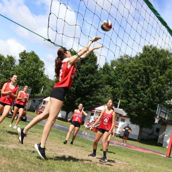 Girl in motion preparing to set a volleyball