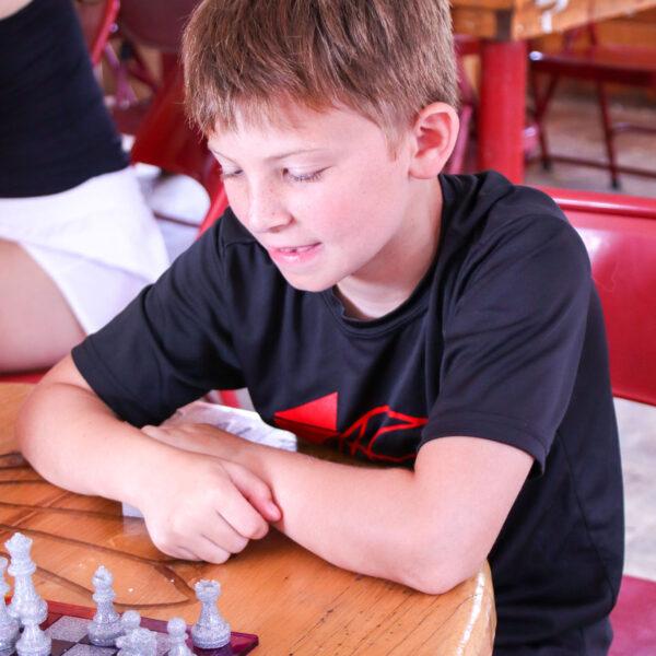 Boy contemplating his next chess move
