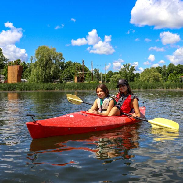 2 girls in a canoe and enjoying the nice weather