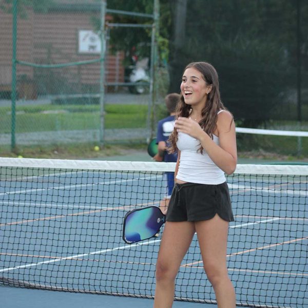 Camper with Pickleball racquet laughing