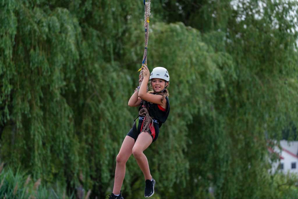 Young girl on zip line at Camp Pontiac